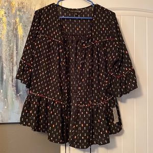 Very cute shirt with it open in the front. You can wear a white tank top under